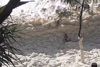 Gold coast swimmer dubbed ’foam man’ after Australia storms